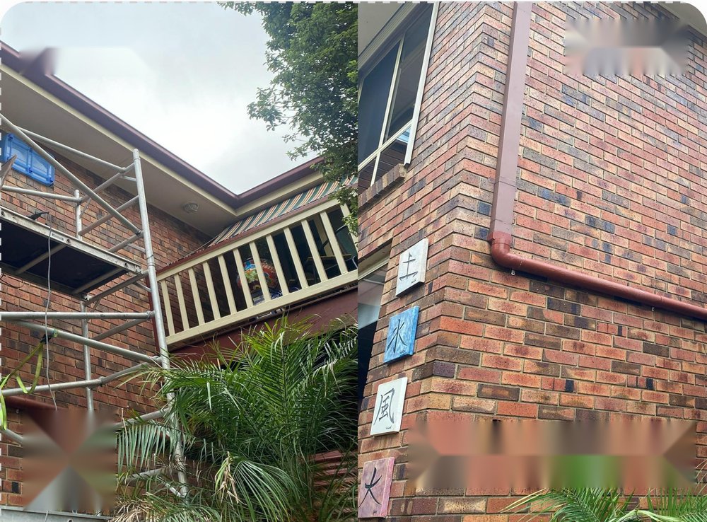 Brick wall under scaffolding beside the finished repointed wall