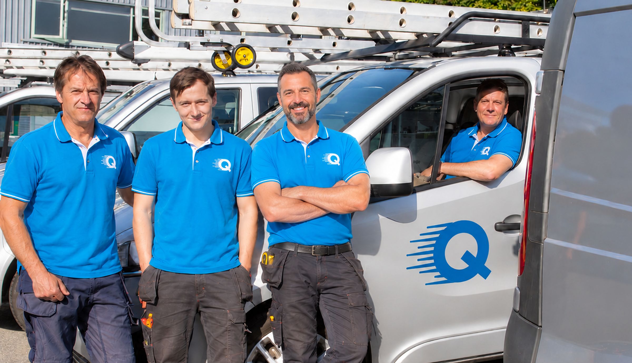 The Quick Replace team in uniform beside their work vans