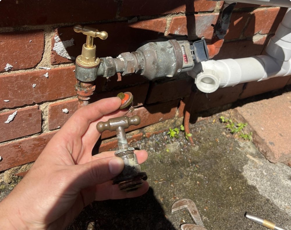 Replacement garden tap on an external brick wall