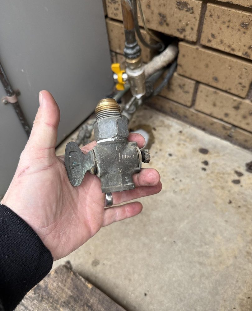 Old corroded plumbing valve removed from beside a hot water unit