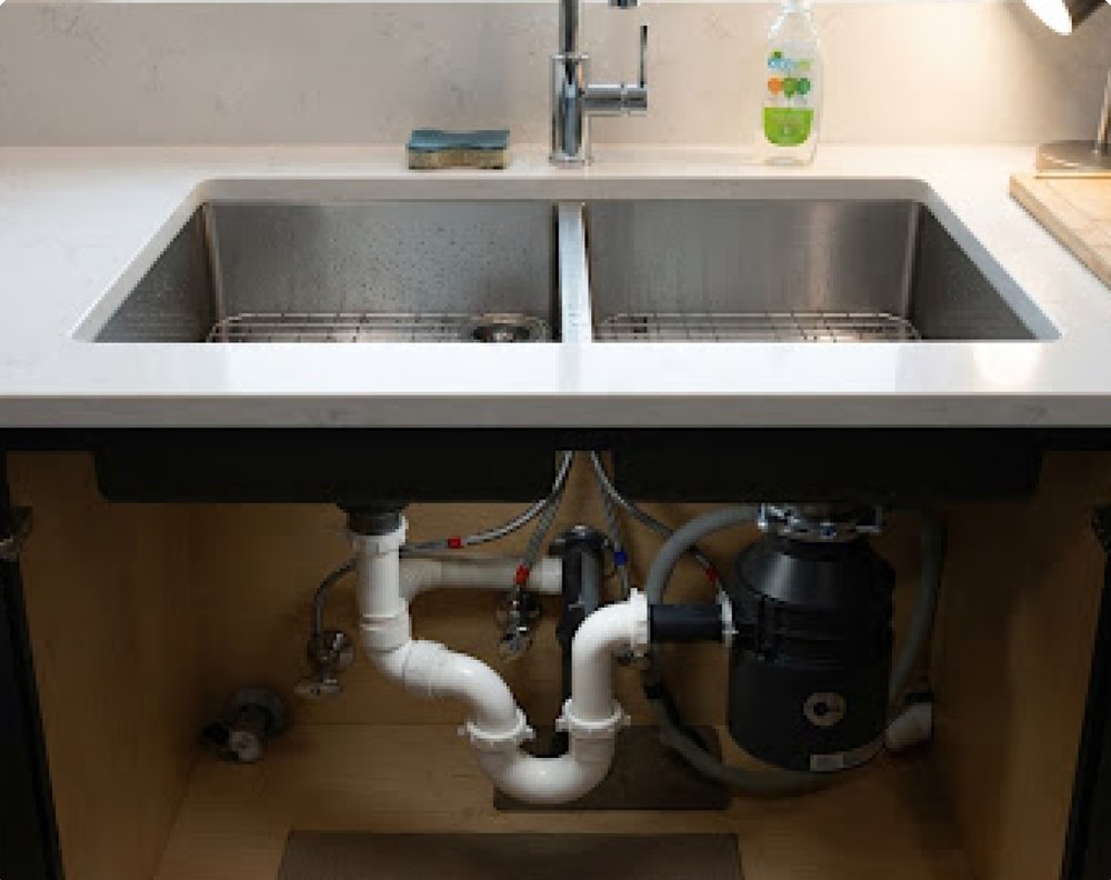 Double kitchen sink with new waste pipes and disposal unit