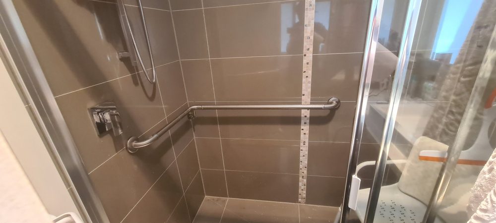 Grab rail installed on a tiled shower wall
