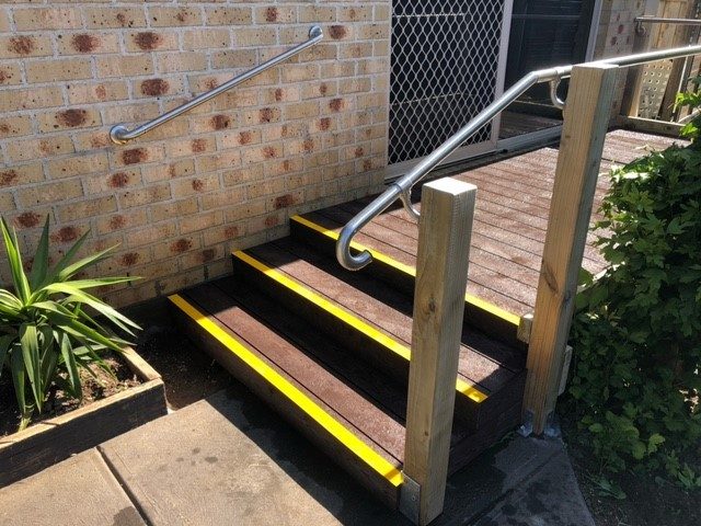 Timber steps with yellow safety nosing and stainless steel handrails
