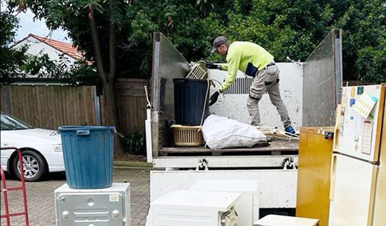 Removalists loading furniture into a truck