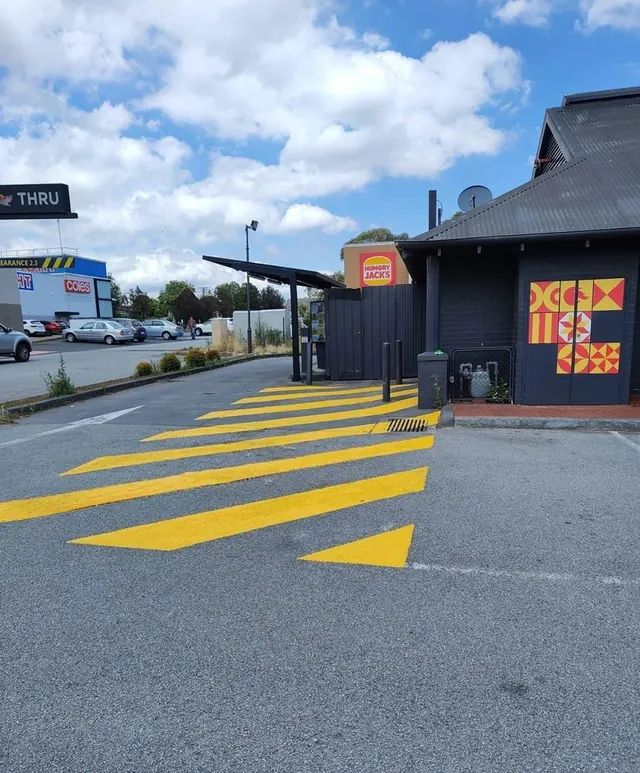Yellow safety line marking painted on a drive-through lane