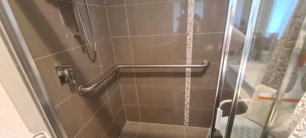 Grab rail installed on a tiled shower wall