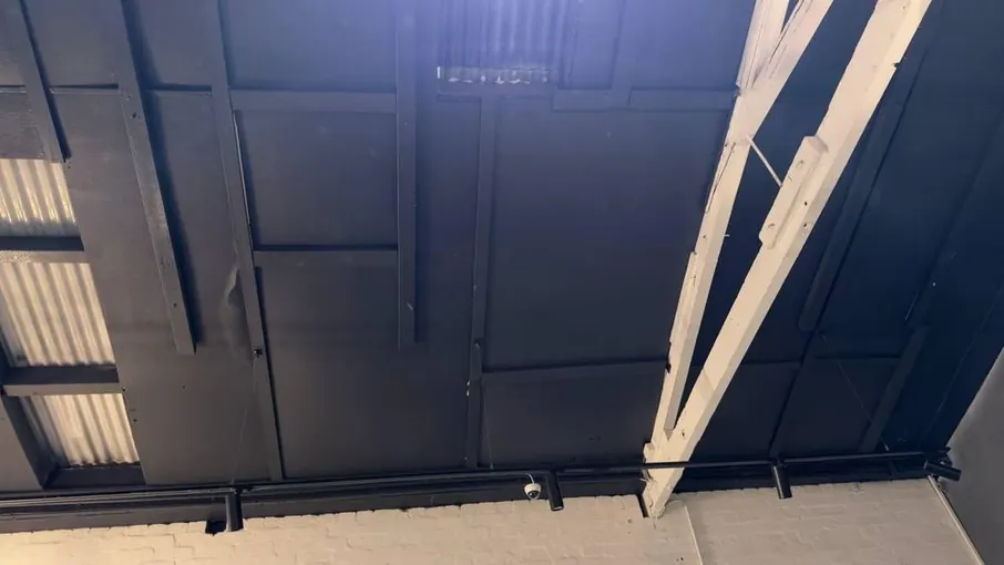 Warehouse ceiling with a water-damaged section to be repaired