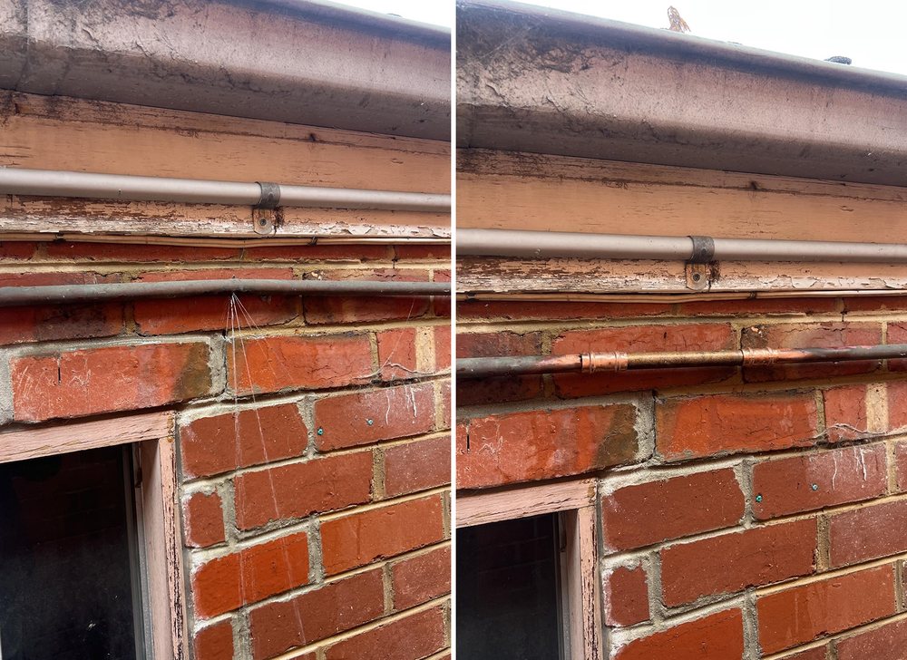 Damaged pipe above a brick wall beside the repaired pipe